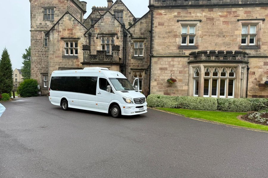 White 16-seater Mercedes-Benz Sprinter executive minibus outside a country house wedding venue
