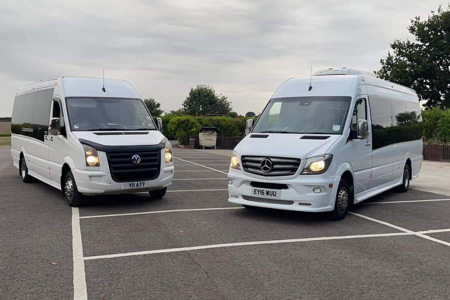 Two ATS Travel 16-seater minibuses, a Volkswagen Crafter and a Mercedes-Benz Sprinter, ready for a multi-vehicle group booking